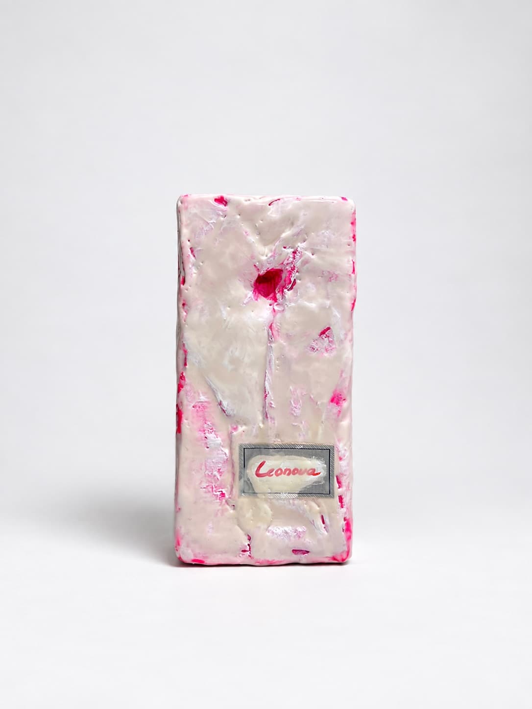 A garment label set into the waxed surface, painted over and signed Leonova in red