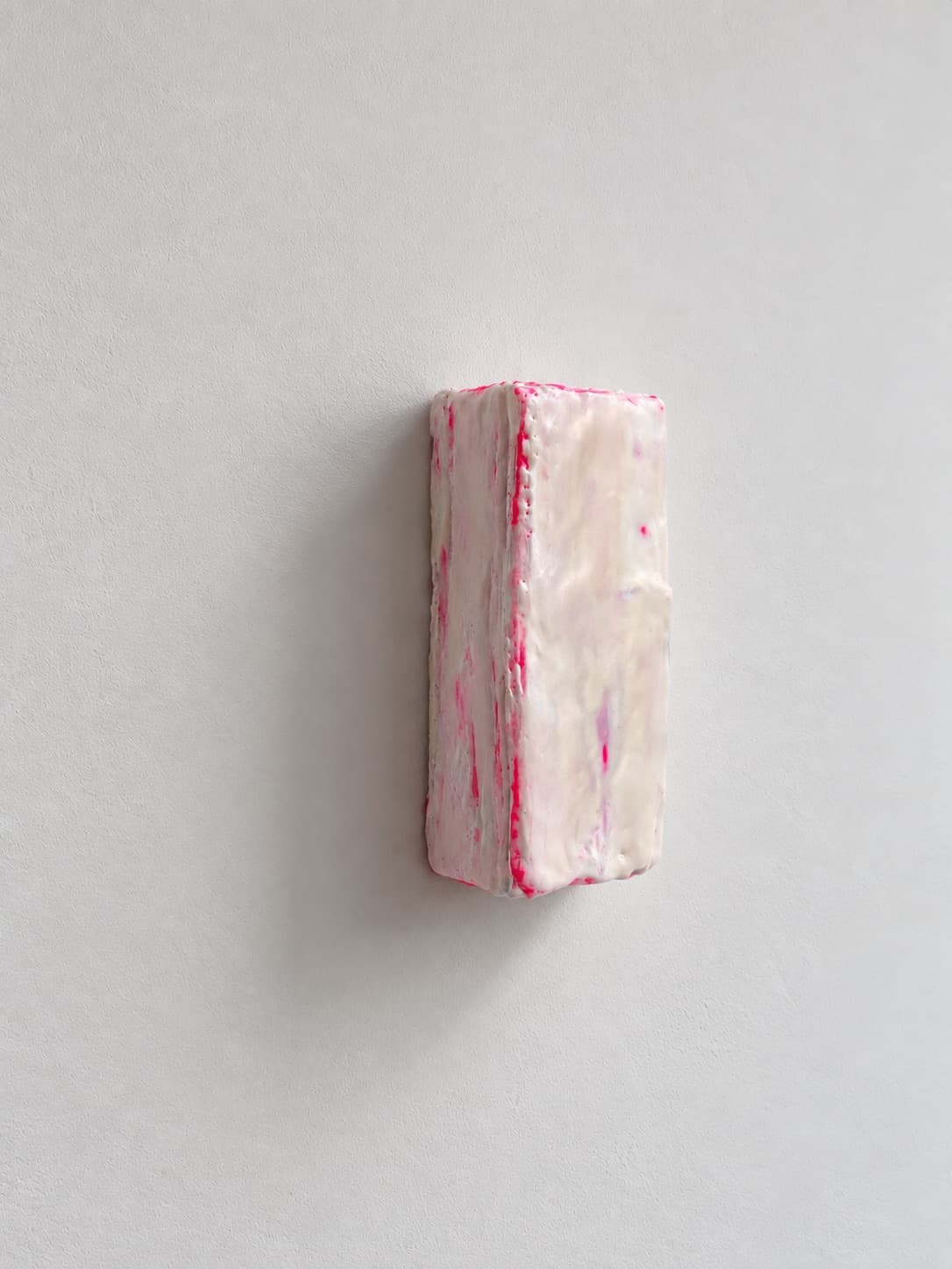 The object seen from the side, standing off the wall