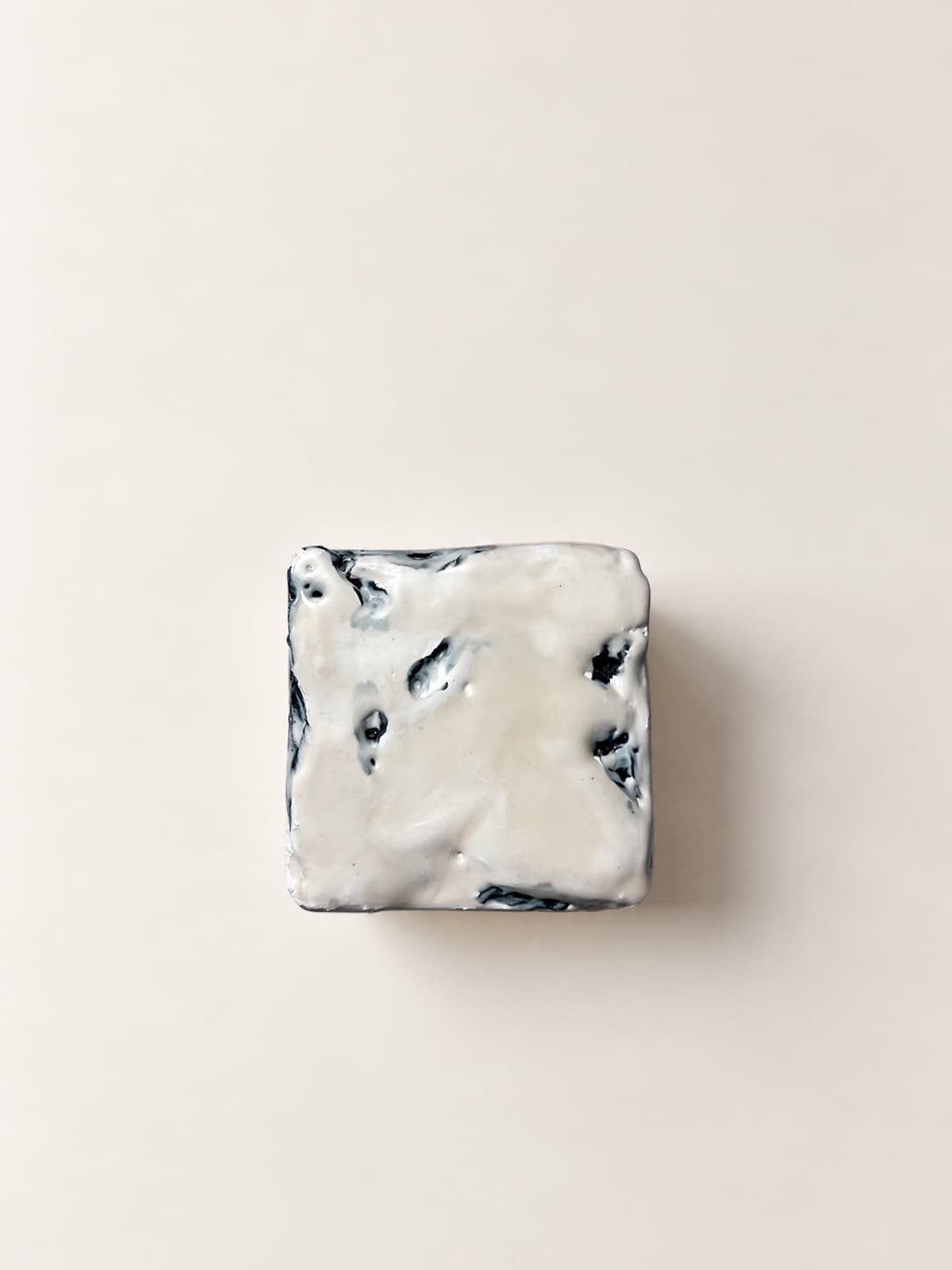 The cube seen square from above, blue bleeding up through the white surface
